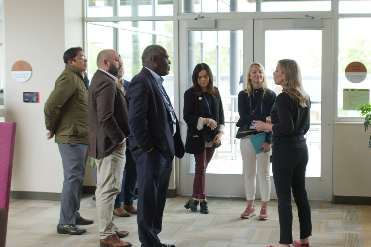 8 people standing in a group during an office tour