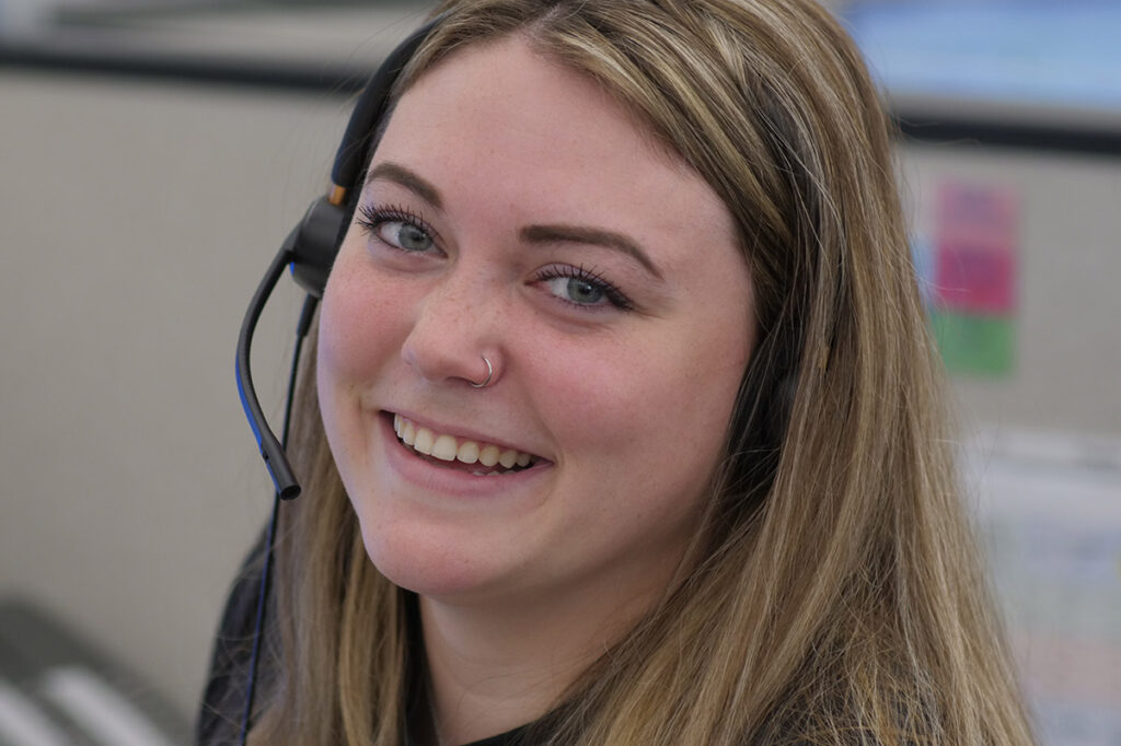 Headshot of a woman wearing a headset